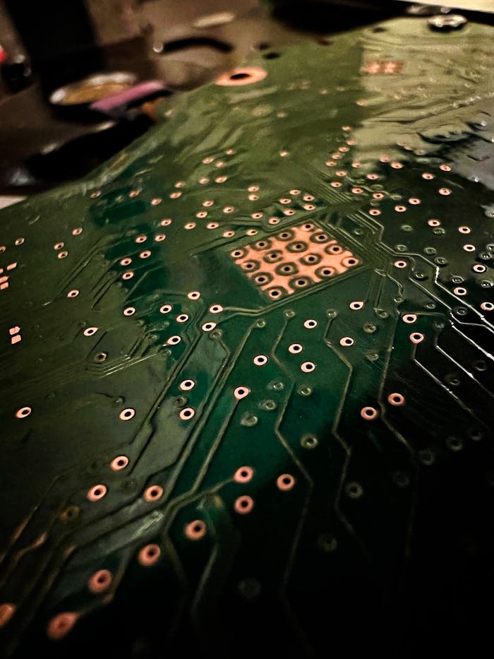 services-01 A close-up photo highlighting the intricate design of a circuit board PCB with visible connections and solder joints.