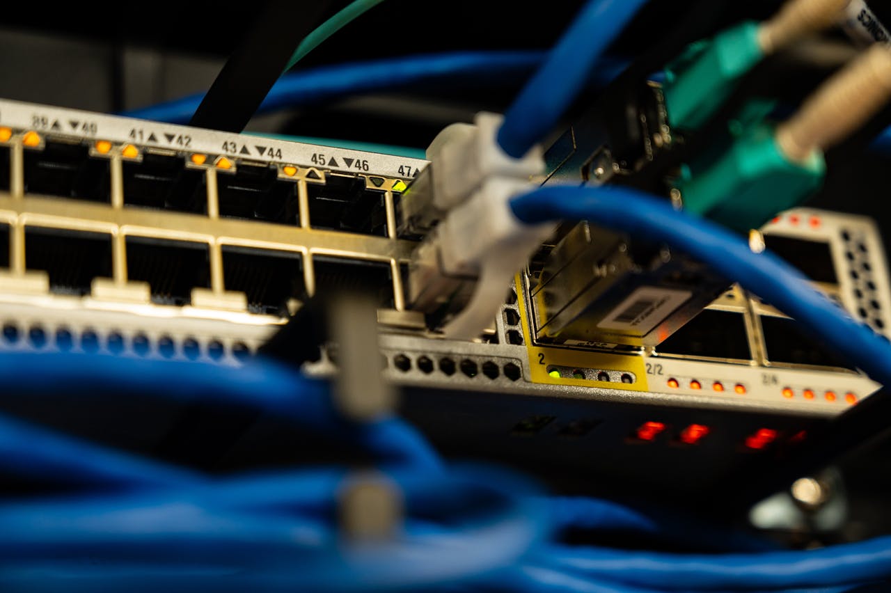 who-we-are Close-up image of ethernet cables plugged into a network switch, showcasing IT infrastructure.